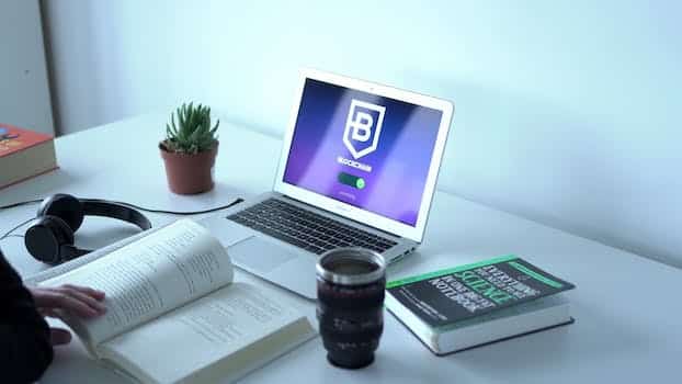 A Laptop and Books on a Table
