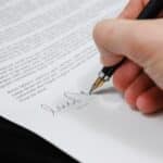 Person Signing in Documentation Paper