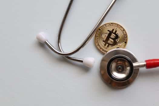Stethoscope and Bitcoin on White Surface
