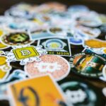 Heap of Bright Stickers with Bitcoin Logo Lying on a Table